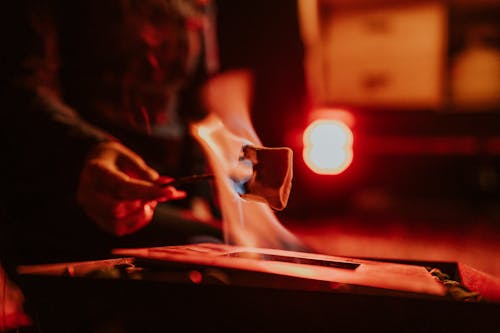 A person is using a torch to light a fire