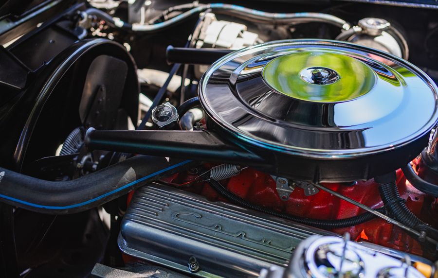 Close-up view of engine components and mechanical parts under an open bonnet