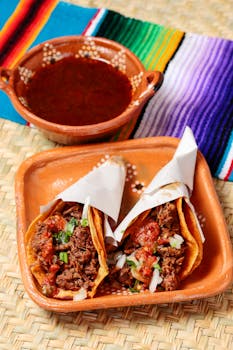 Savor the authentic Mexican tacos filled with spicy beef and vegetables, served with red sauce.
