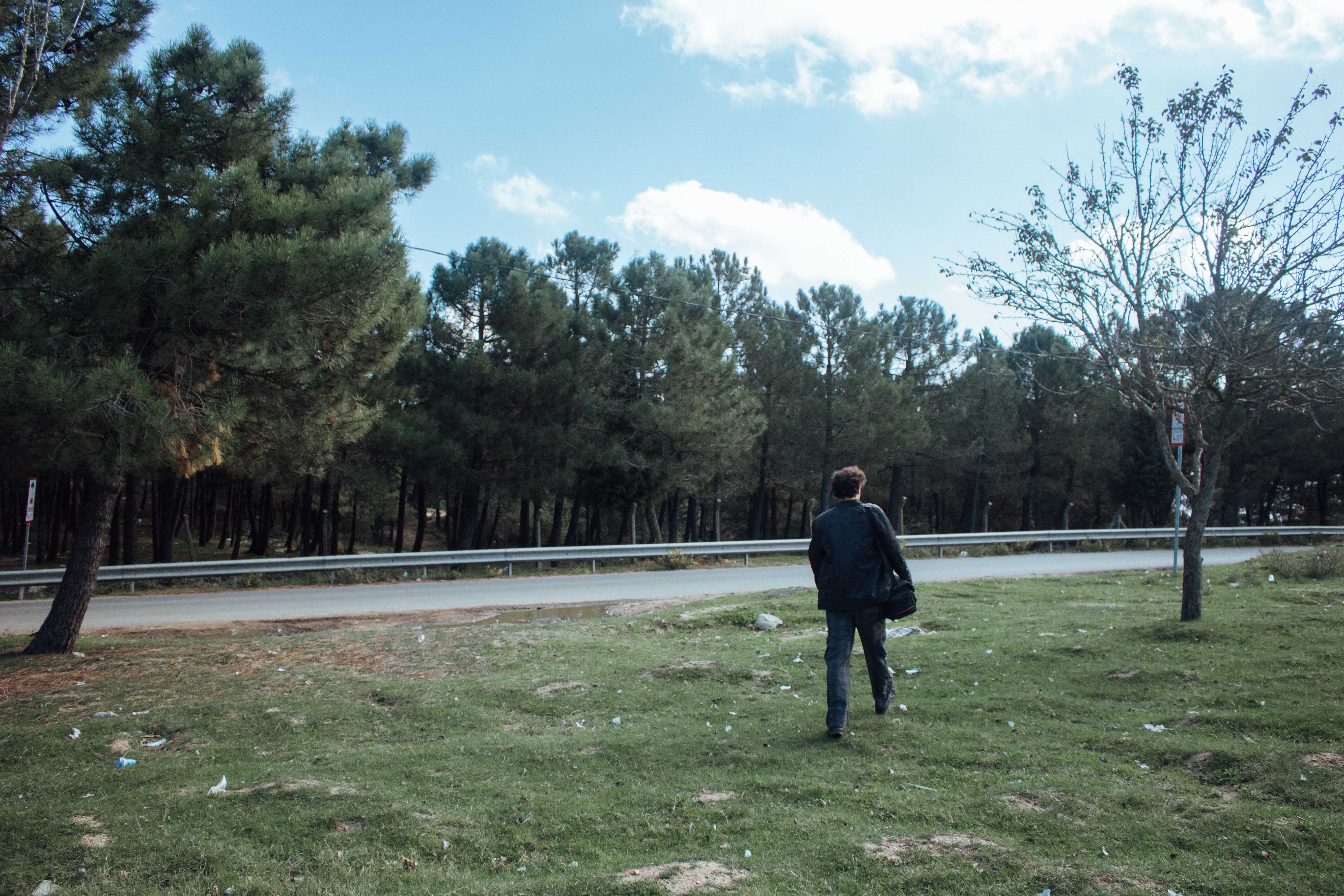 Man Walking on Grass Field · Free Stock Photo