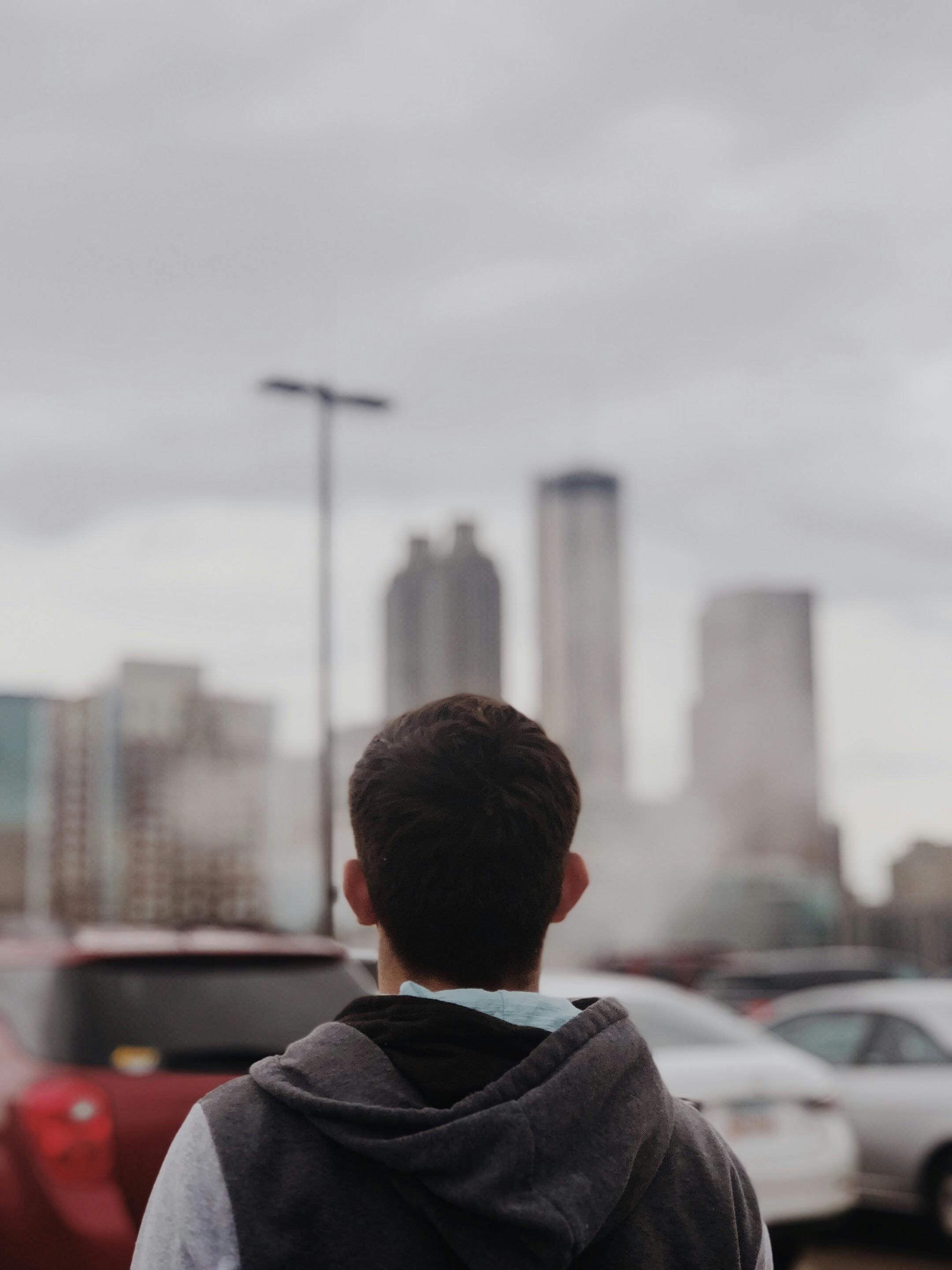 man standing near parked vehicles