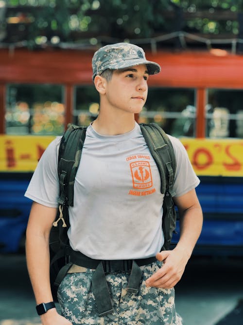 Free Man Wearing Military Uniform Carrying a Backpack Stock Photo