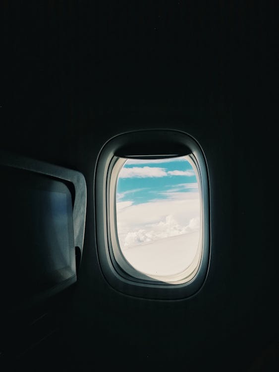 Gratis lagerfoto af fly vindue, flyrejse, flyvemaskine