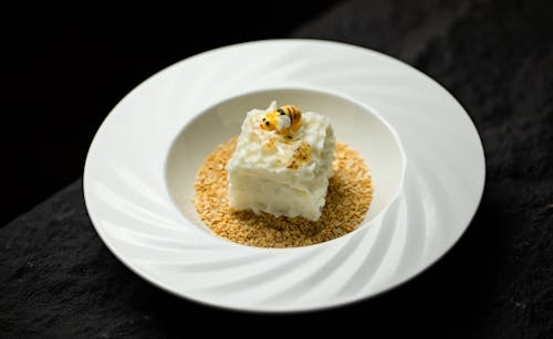 A white plate with a piece of food on it