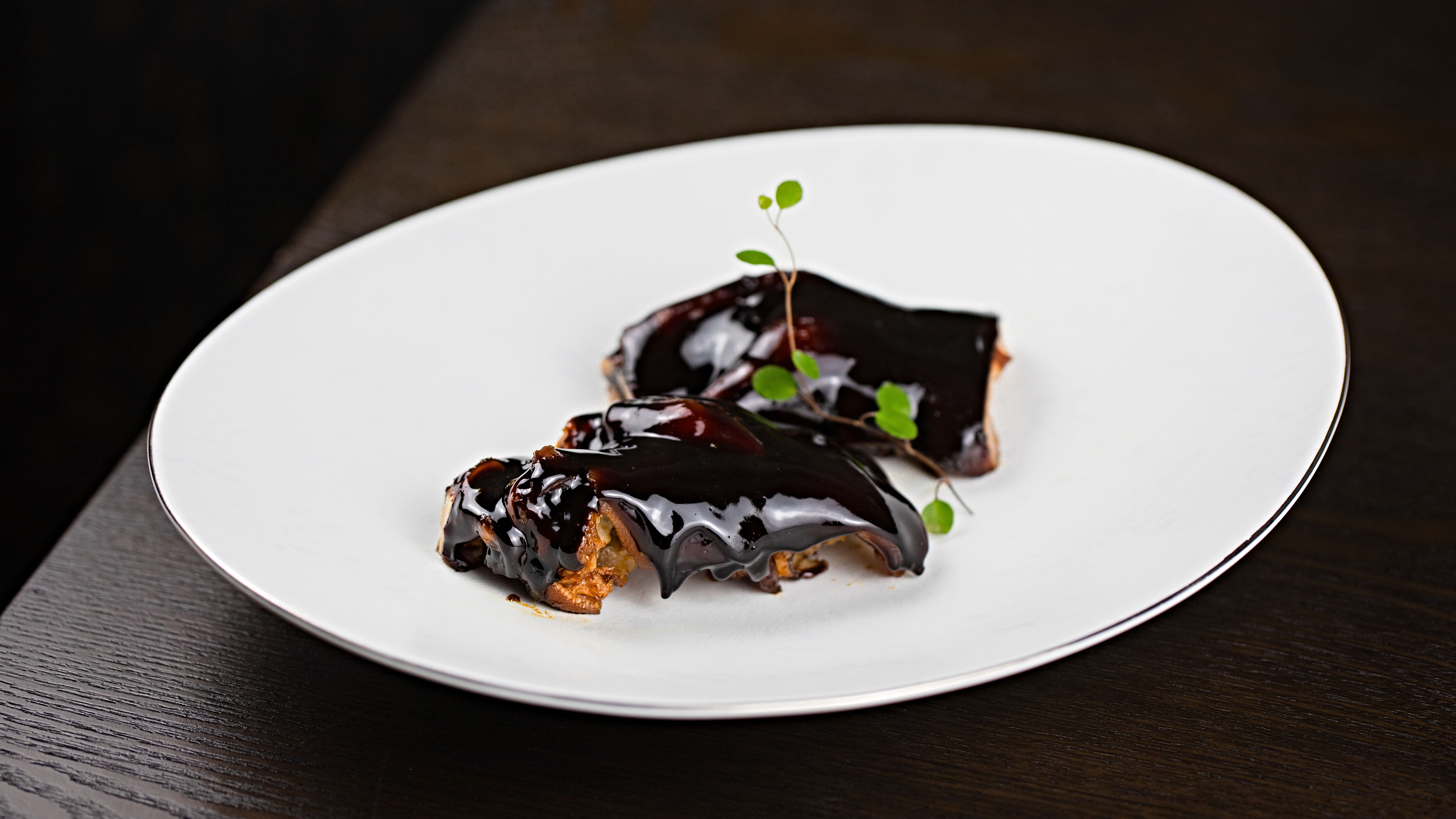 Glazed ribs on a dark ceramic plate