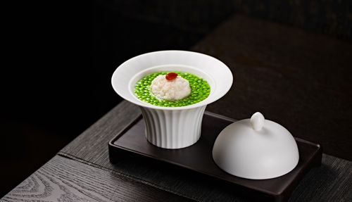 Free Close-up of a gourmet dish with green peas and dumpling in a porcelain bowl, perfect for food photography. Stock Photo