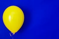 Yellow Balloon on Blue Background