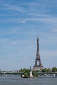 Stunning view of the Eiffel Tower and Seine River in Paris, highlighting iconic French architecture and culture.