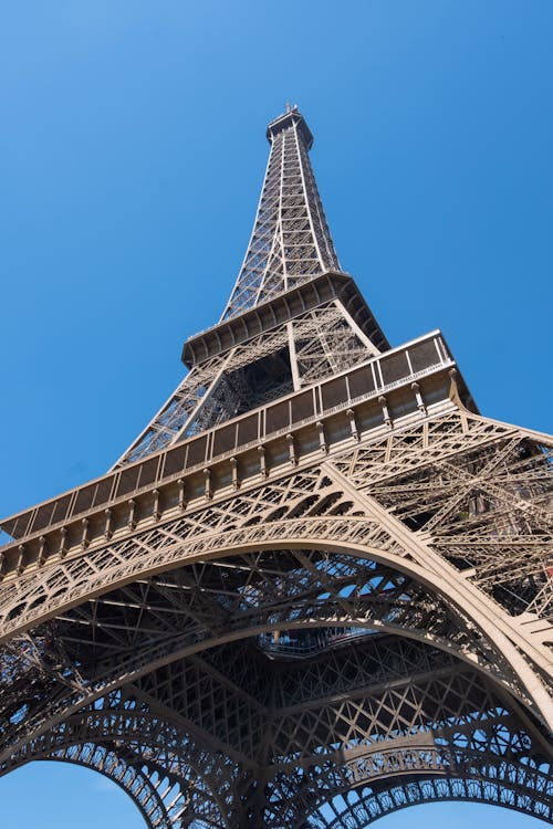 The eiffel tower is shown against a blue sky