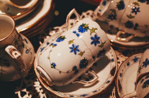 Free A beautifully detailed floral porcelain tea set with gold trim, perfect for elegant gatherings. Stock Photo