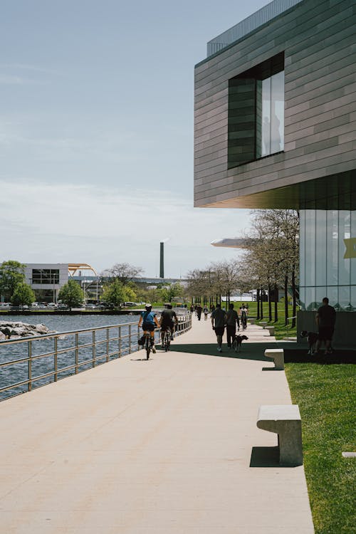 People biking by a river