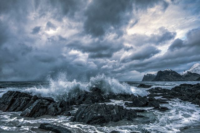Waves crashing against rocks under a stormy sky — photo by stein egil liland on Pexels
