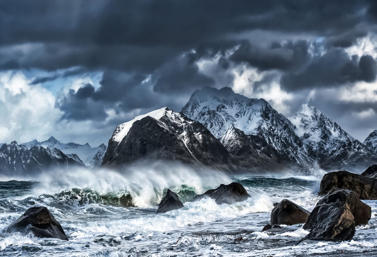 captivating stormy seascape with rugged lofoten mountains and crashing