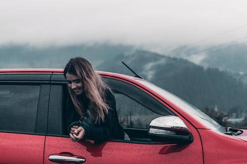 Free Woman Inside Red Vehicle Stock Photo