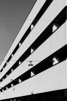 Black and white photo showcasing minimalist architecture with clean lines and sharp angles in Almere.