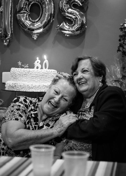 Grayscale Photography Of Two Laughing Women