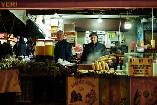Explore a bustling Turkish food stall at night with vendors and vibrant corn display.