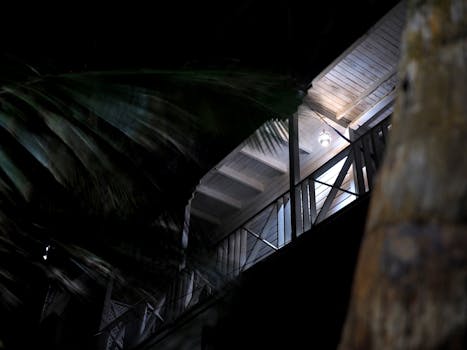 A modern house in Barbados at night, illuminated with ambient lighting.