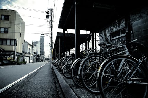 Grayscale Photography of Bikes Park Outside