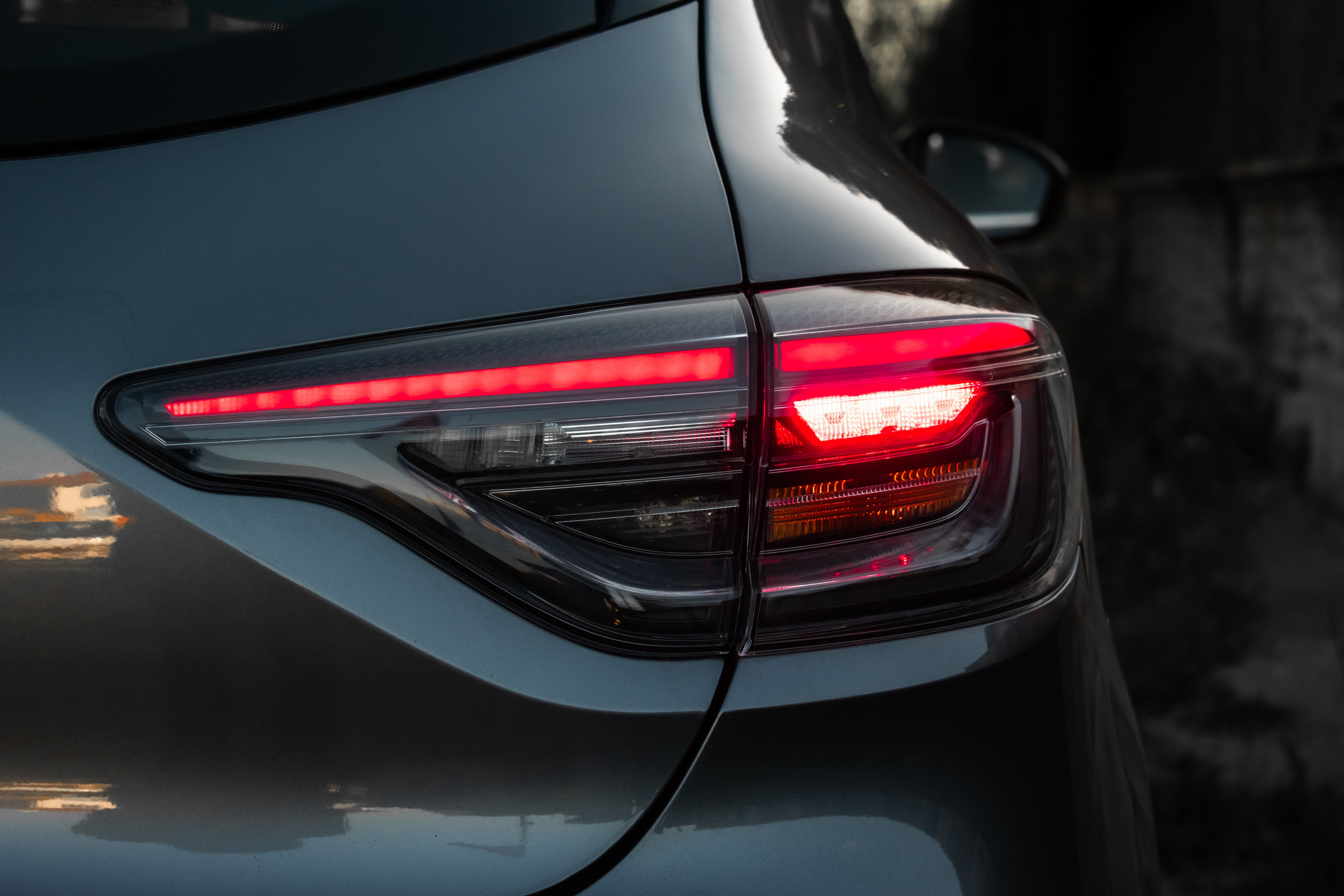 Close-up of a modern car's taillight design, captured at twilight.