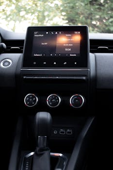 Close-up of a car dashboard featuring a modern touchscreen display and climate controls.