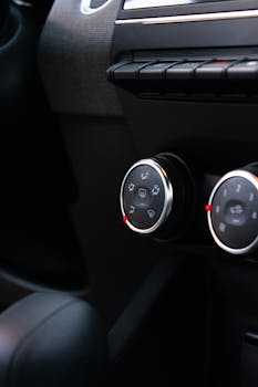 Close-up view of car climate control dials in a vehicle interior.