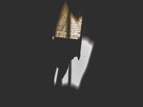 Artistic interplay of shadows and light on a textured fabric indoors.