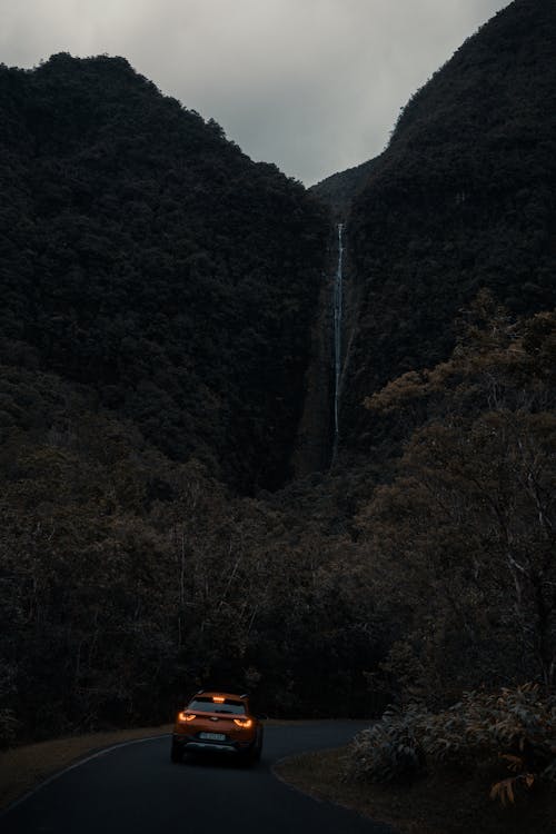 Free Orange Car Across Waterfalls Photo Stock Photo