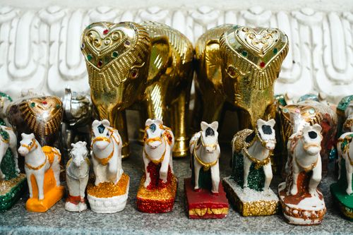 Free Vibrant gold and multicolored elephant and horse figurines, representing cultural and spiritual themes. Stock Photo