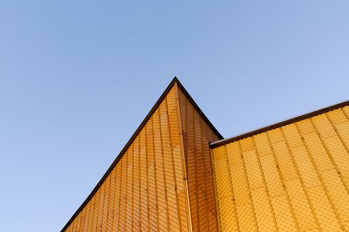 Free Low angle view of a modern building with yellow walls and unique patterns in Berlin, Germany. Stock Photo