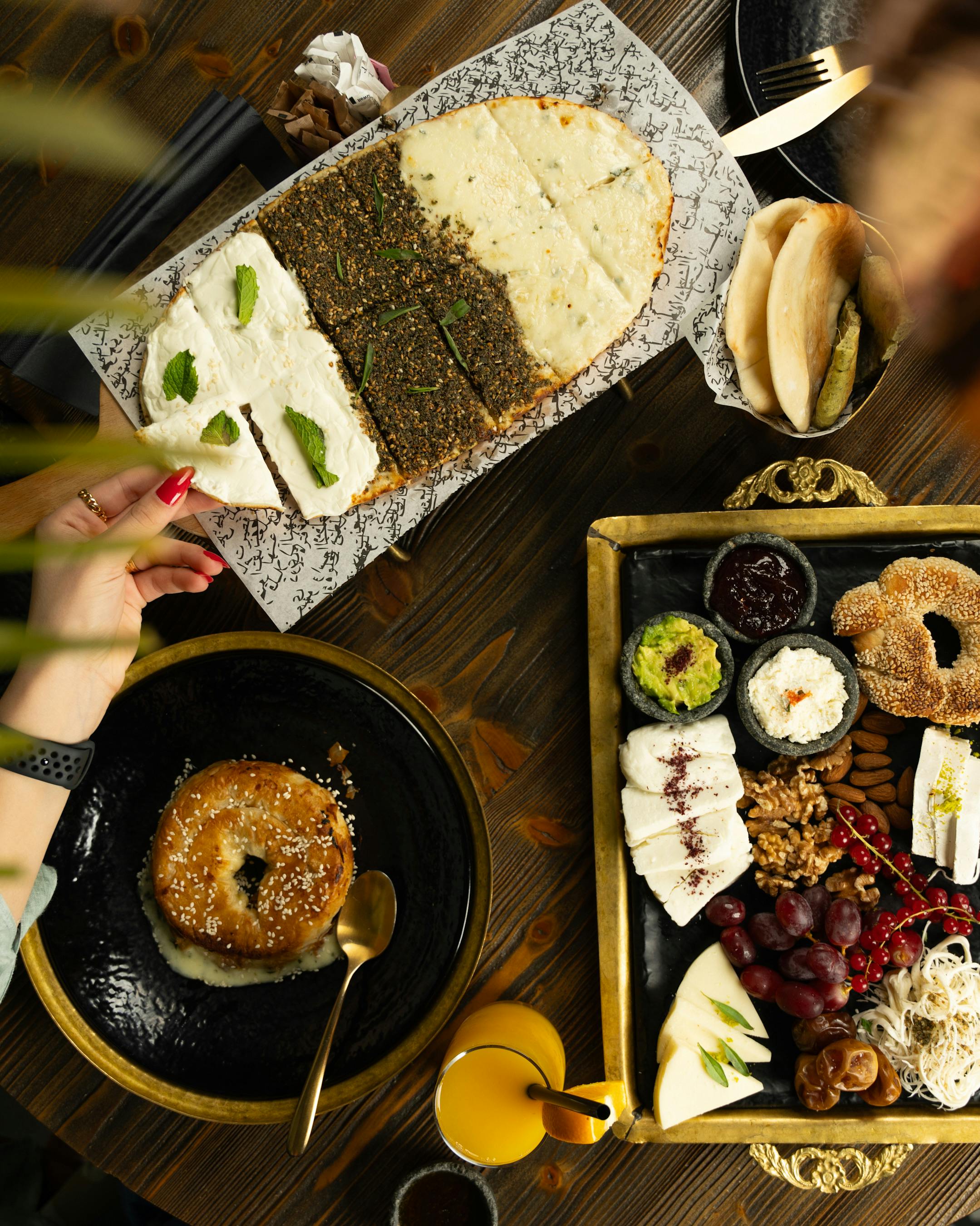Top view of diverse Middle Eastern breakfast with fresh bread and dips.