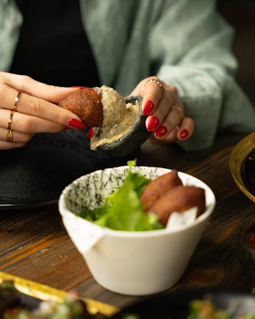 A woman is eating food with her hands