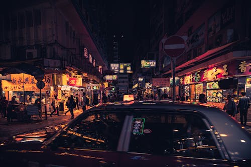 Free Photo of Taxi Near Buildings During Nighttime Stock Photo