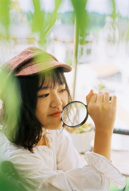 Free Photo of Girl Holding Magnifying Glass Stock Photo