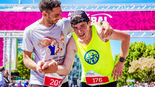 Man Helping A Tired Runner