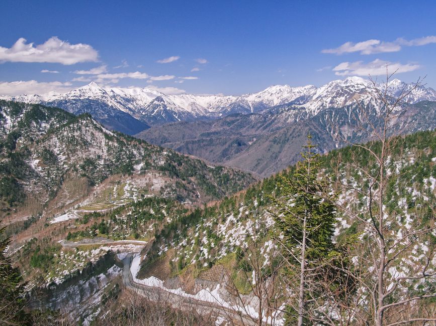 Panoramic view of snow-capped mountains under a clear blue sky, perfect for nature enthusiasts.