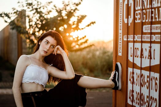 日落时分，一位年轻女子在容器旁若有所思地摆着姿势，神情随意而沉静