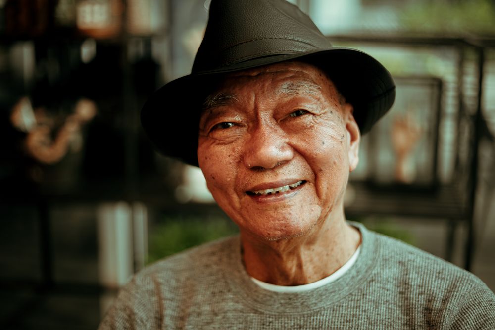 Bad Breath From Dentures, Bridges and Implants: Why Cleaning Isn't Enough 2 Relaxed older man at ease in conversation without worrying about denture odour