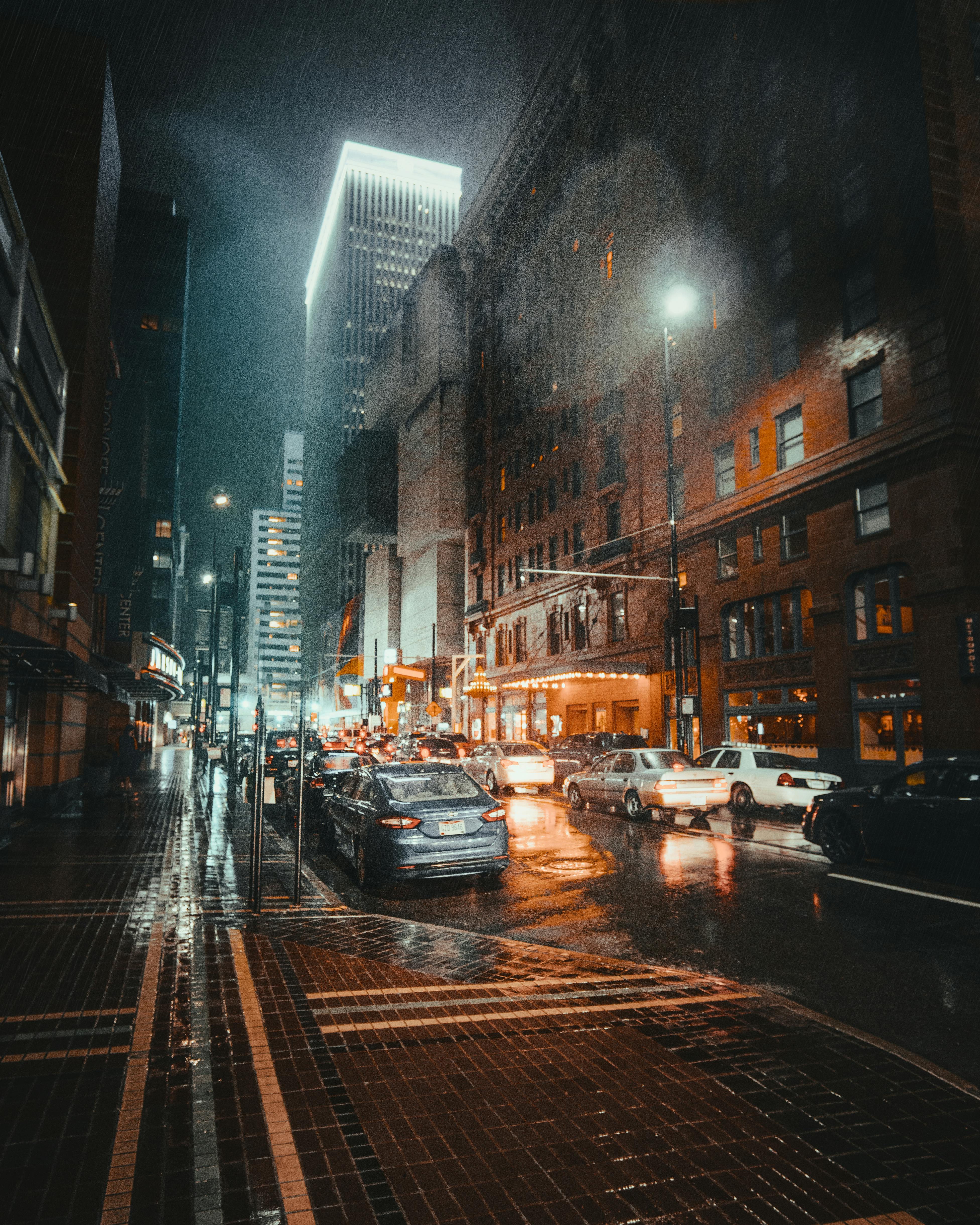 photo of vehicles on road while raining