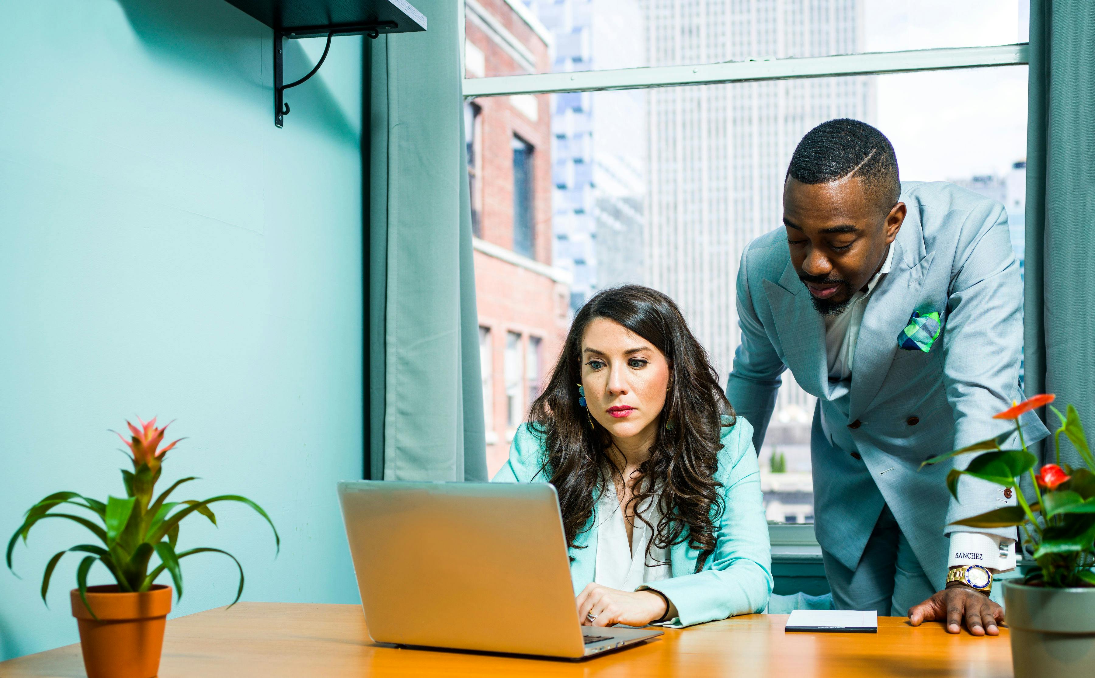 Man Wearing Gray Suit Besides Woman