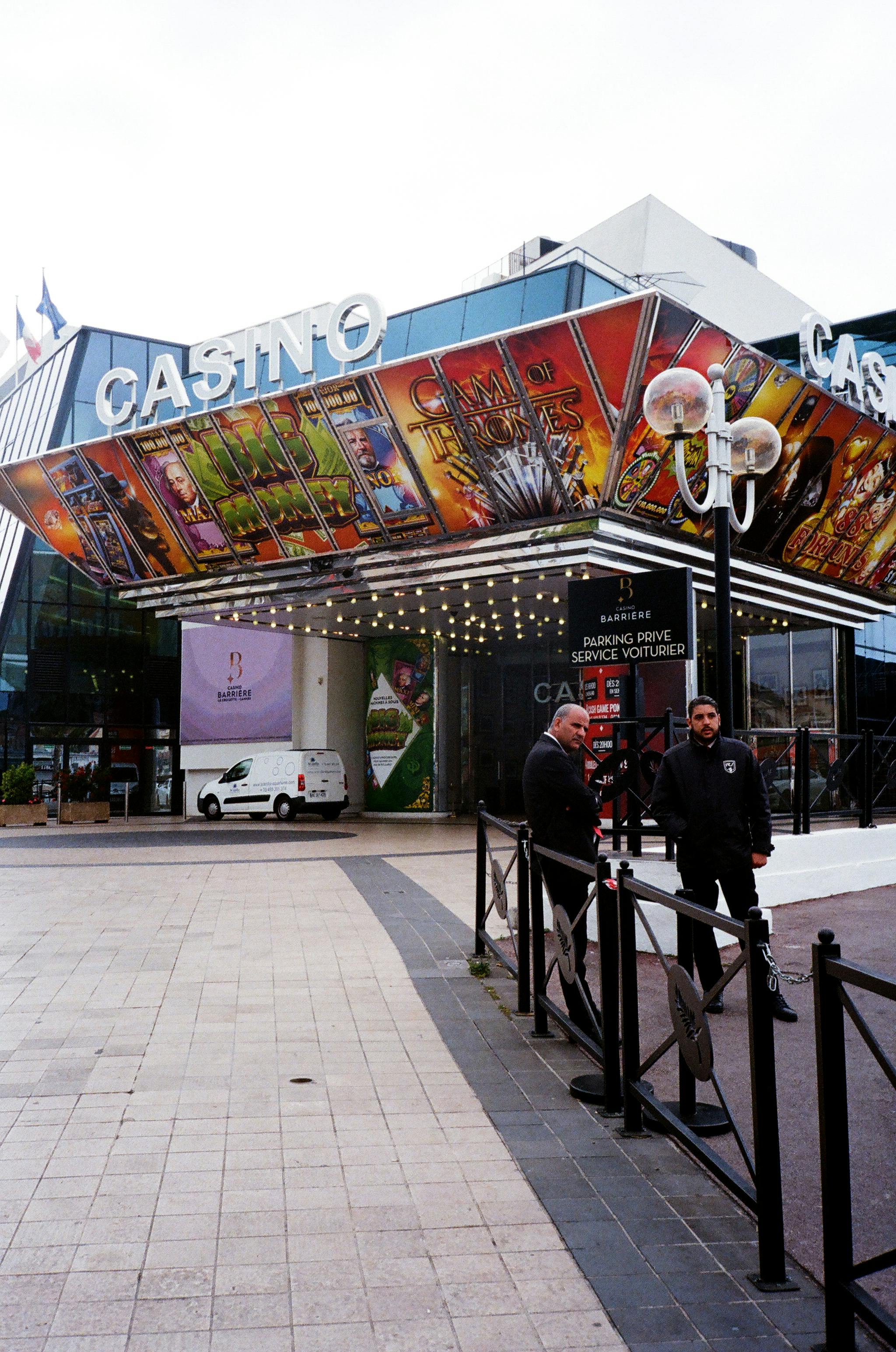 Two men standing outside a casino building. | Photo: Pexels