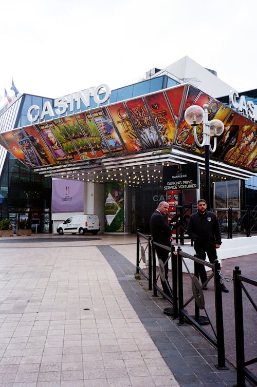 Two Men Standing Outside Casino Building