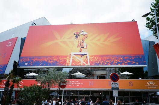 Large billboard at the Cannes Film Festival showcasing vibrant imagery. by Darya Sannikova