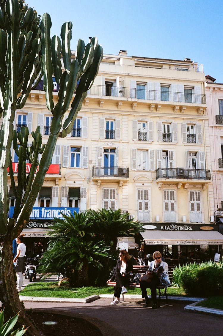 People At The Park Near White Painted Hotel