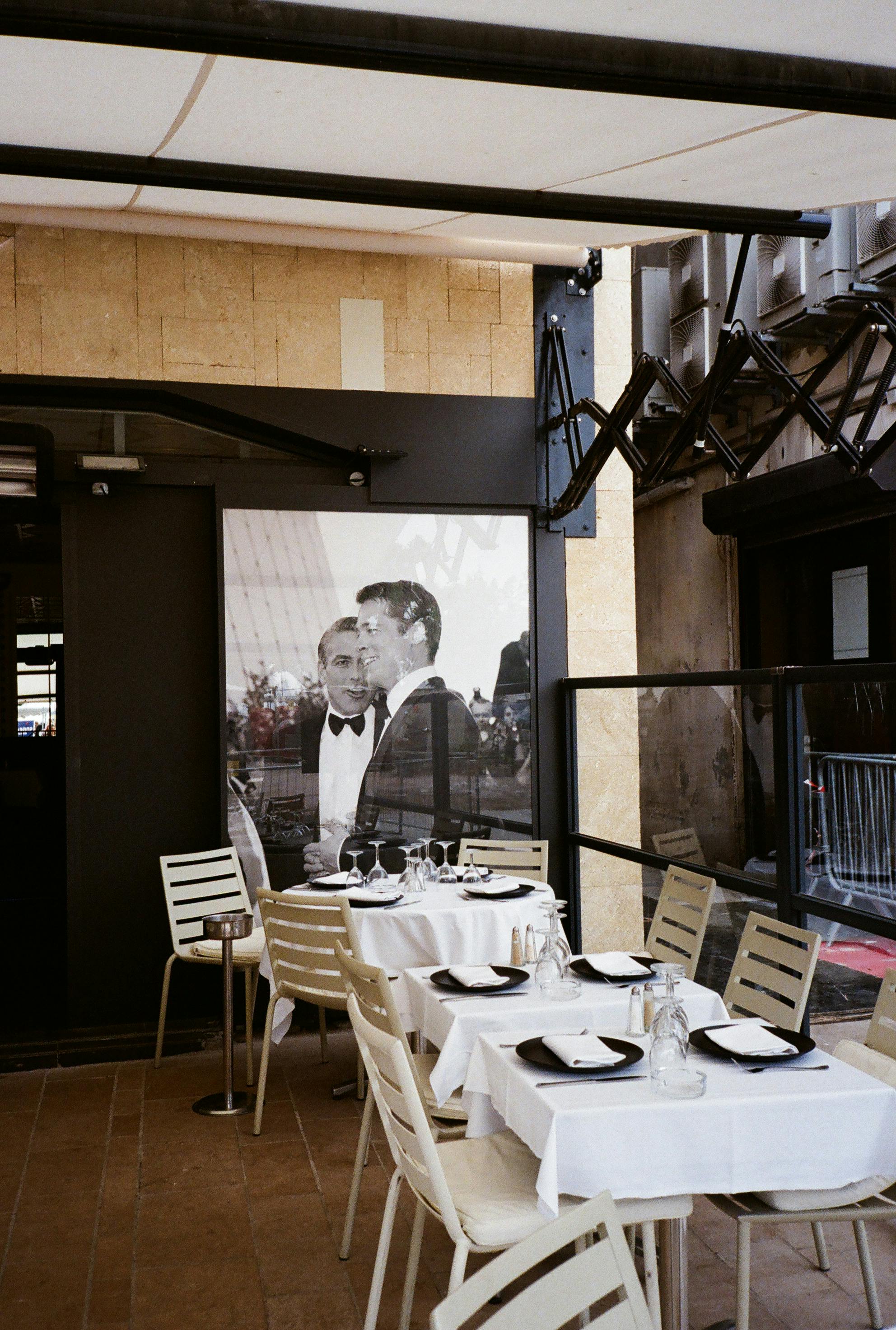 Two Men in Black Suit Jackets Poster In A Restaurant · Free Stock Photo