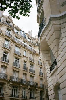 Charming view of Parisian architecture with ornate balconies and classic stone facades.