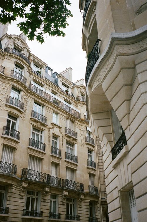 Free Charming view of Parisian architecture with ornate balconies and classic stone facades. Stock Photo