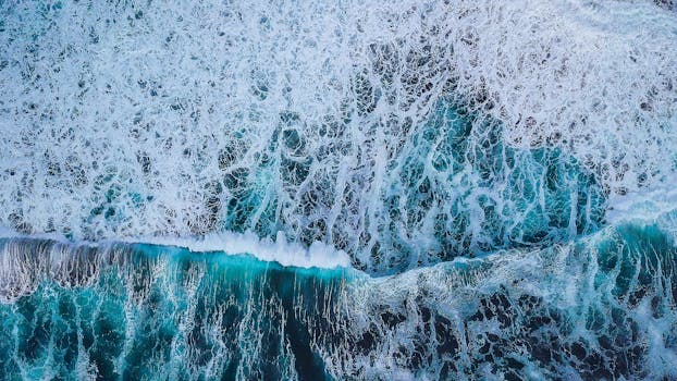 迷人的鸟瞰图中，蓝色海浪汹涌澎湃，展现了大自然的混乱与美丽