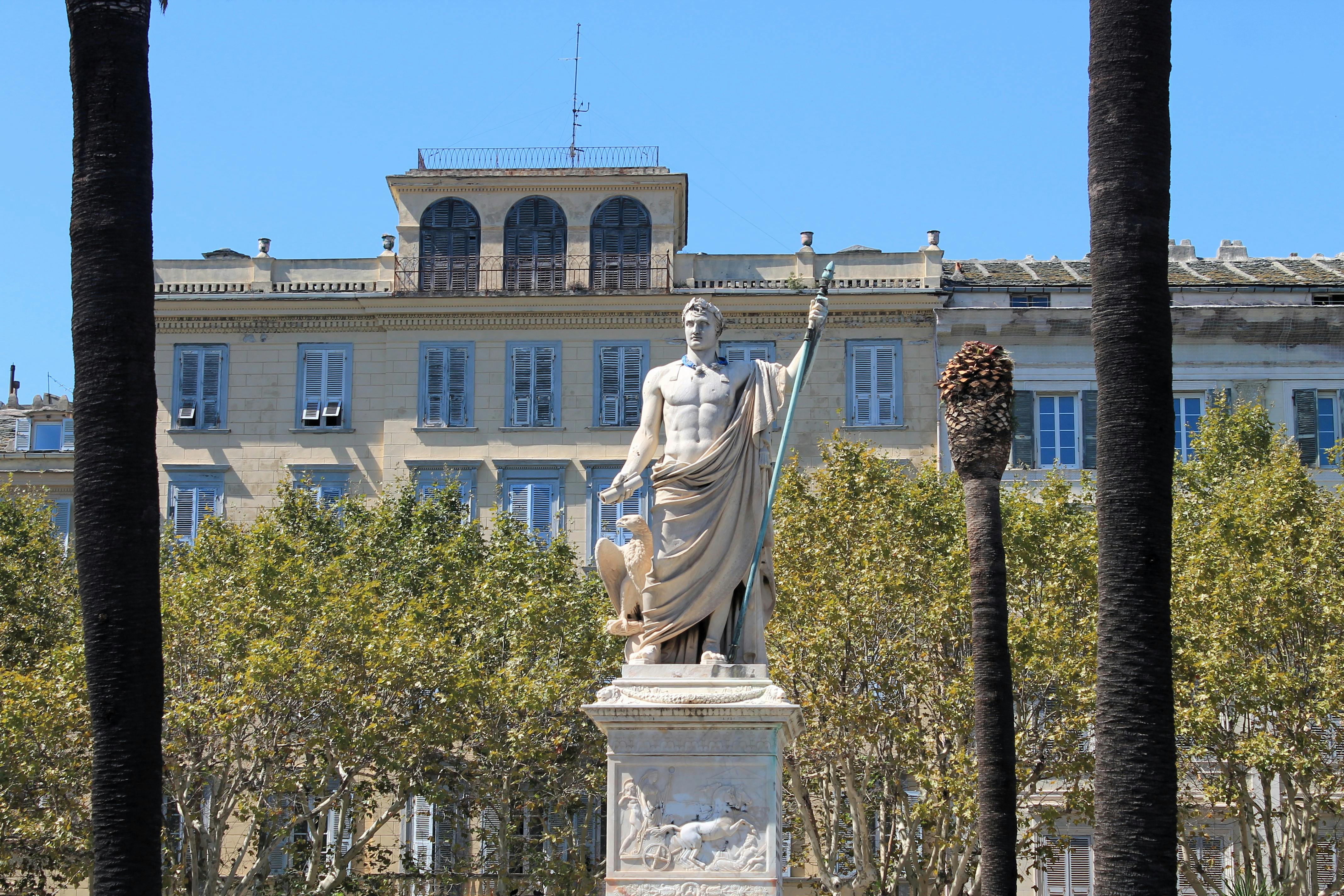 A stunning statue of Napoleon Bonaparte in Bastia, Corsica, set against historical architecture.