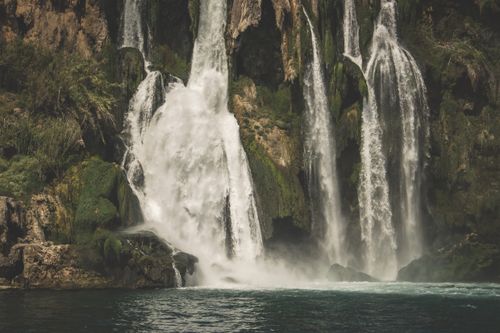 Free Stunning waterfall cascading over mossy rocks in a lush, natural environment. Stock Photo